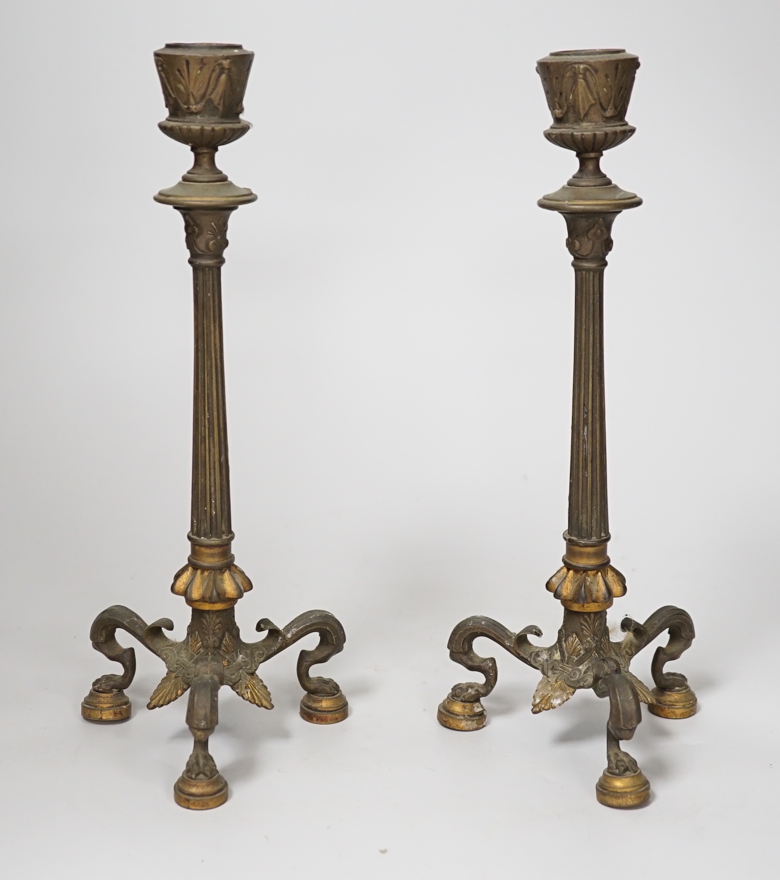 A pair of early 19th century brass candlesticks, 26cm
